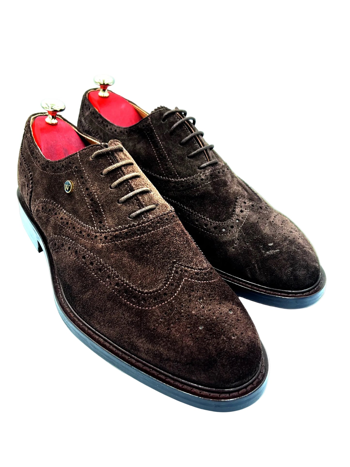 Brown suede dress shoes with red lining on a white background