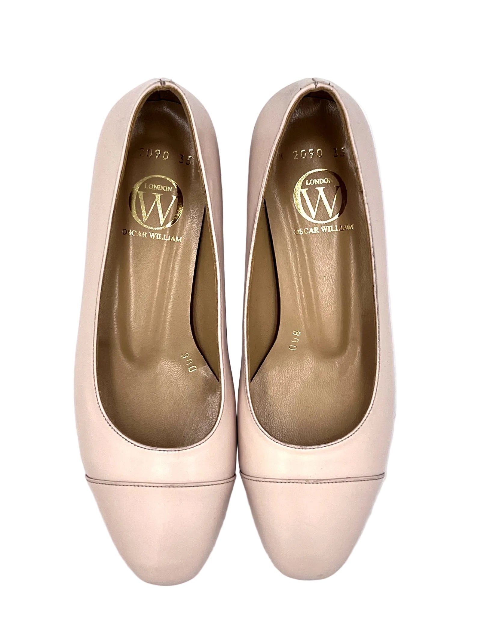 Pair of light pink shoes with a visible brand logo on a white background