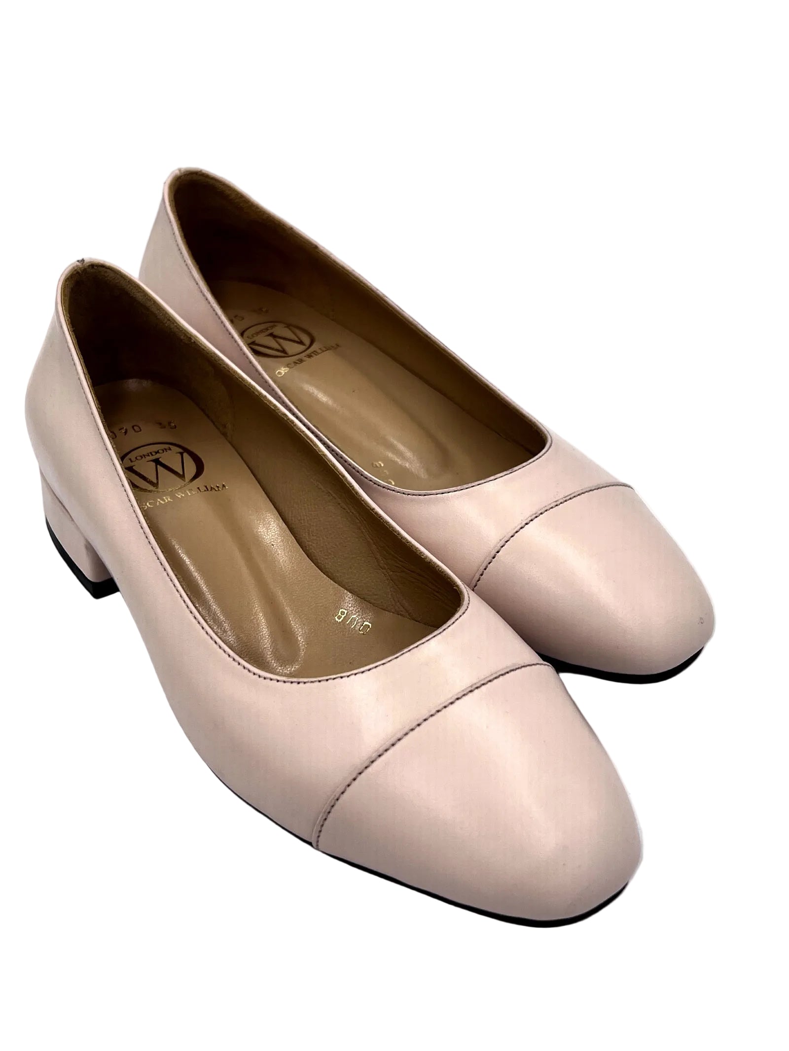 Pair of light pink shoes on a white background