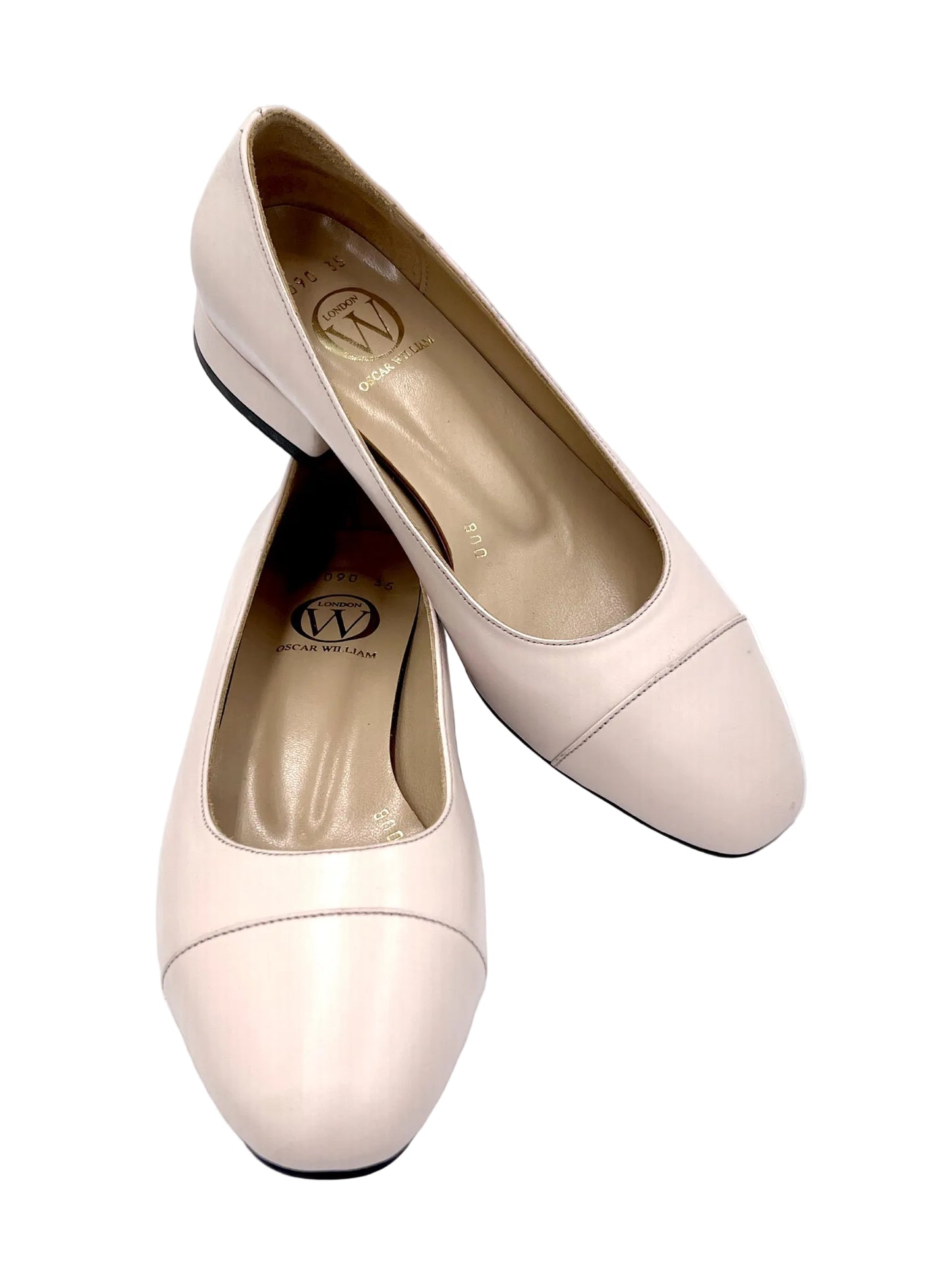 Pair of light pink shoes on a white background