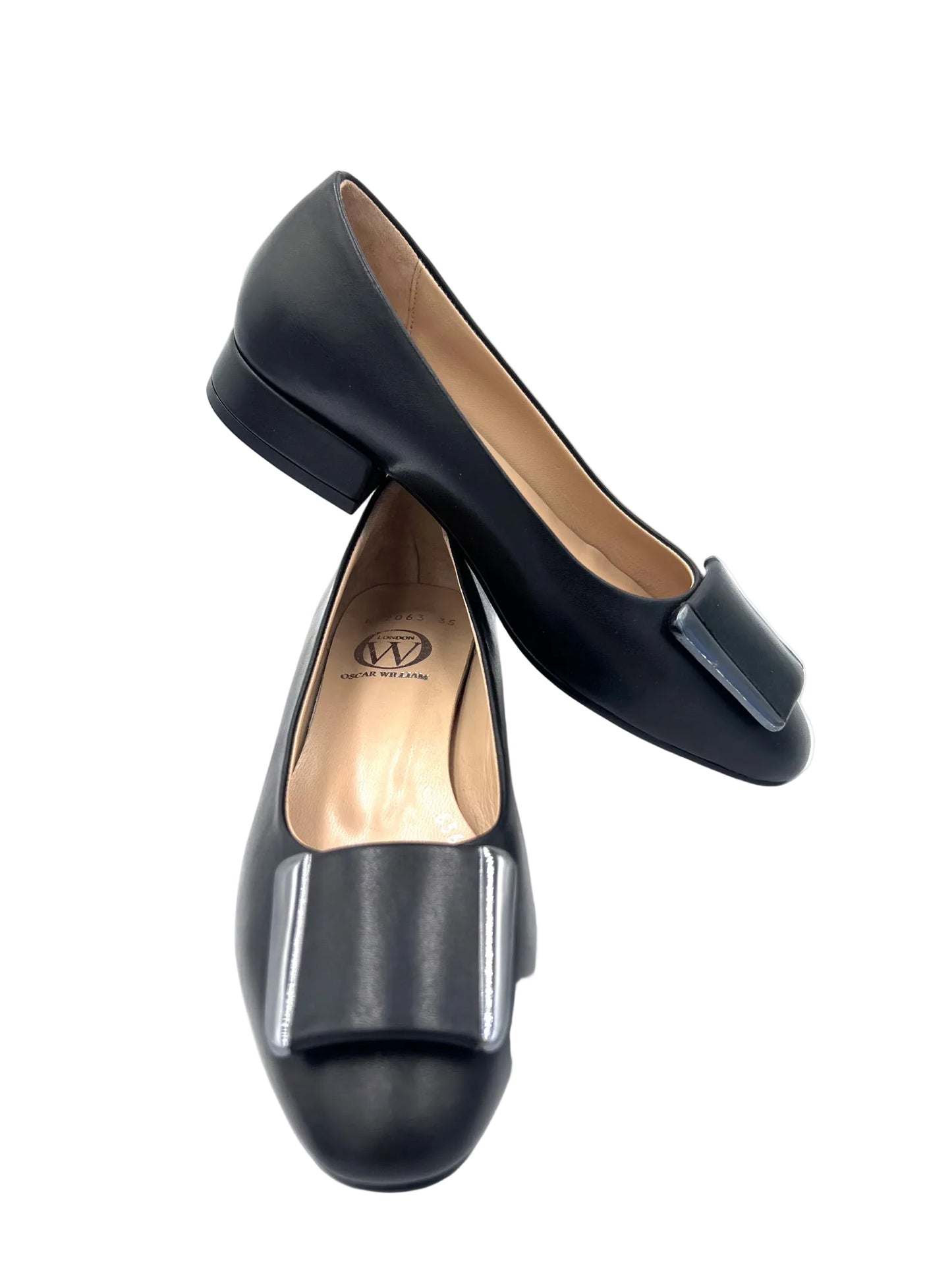 Pair of black flat shoes on a white background