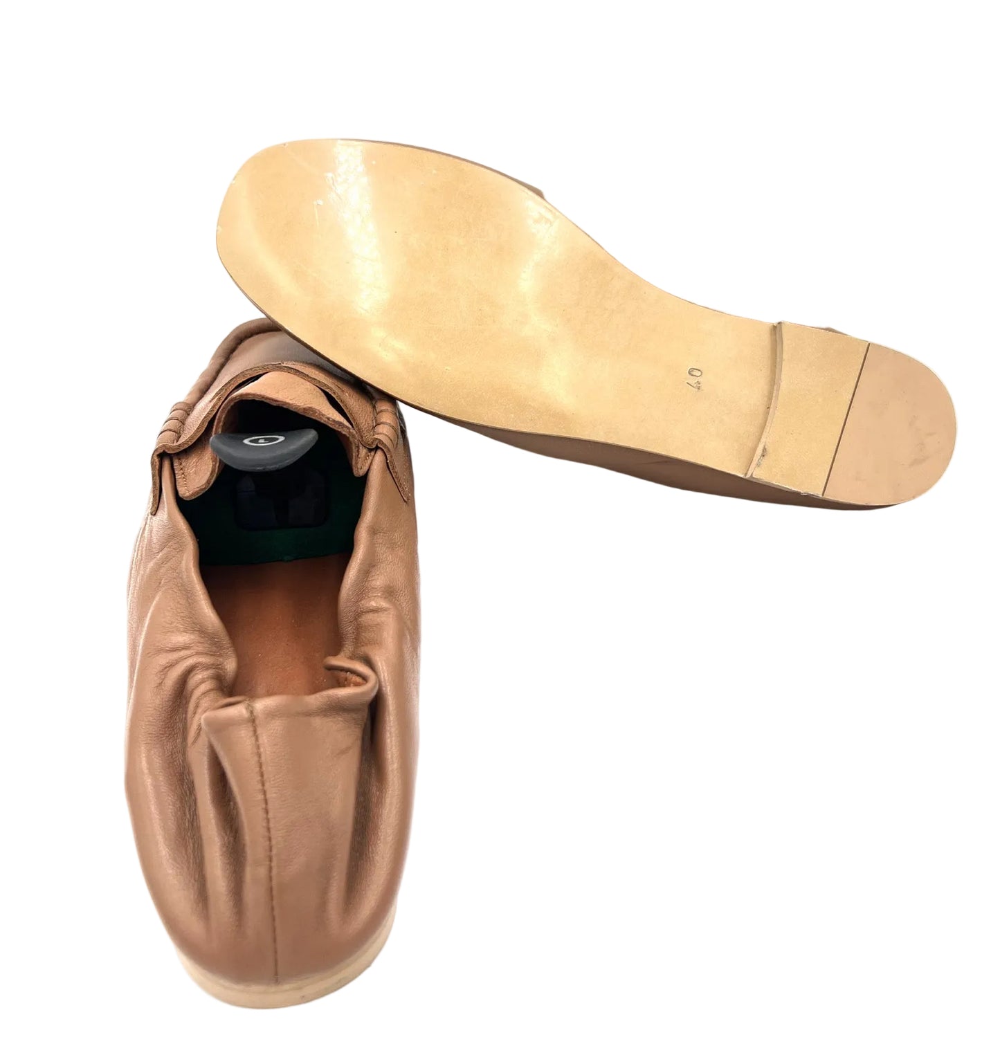 Brown leather shoe with wooden sole on a white background