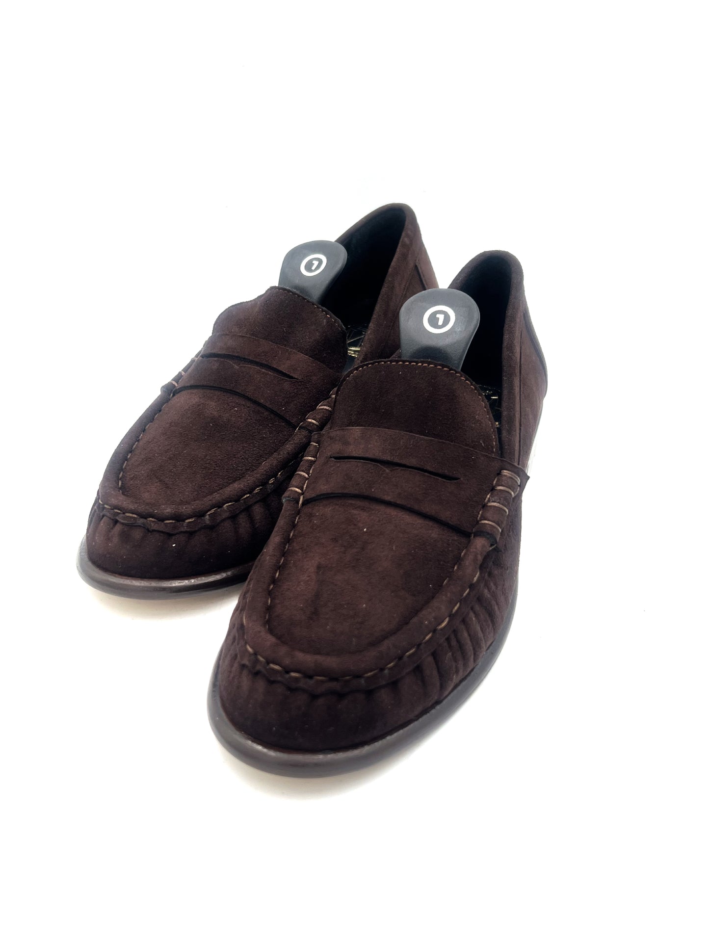 Pair of brown suede loafers on a white background