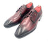 Pair of maroon leather dress shoes with red lining on a white background